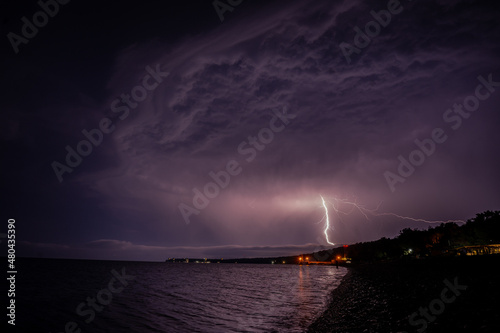 Obraz na płótnie Lightning over the sea at night in the south w salonie