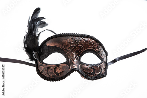 Carnival mask brown color with black feather decoration isolated on white background, © Rawf8