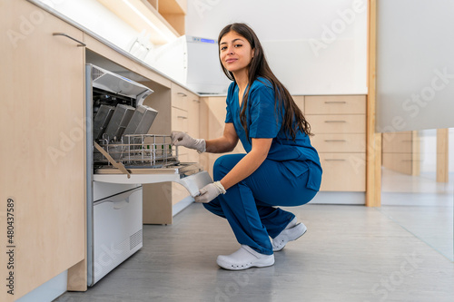 Nurse crouching checking machine for the disinfection of medical material in a hospital