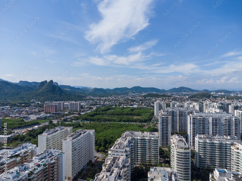Aerial view of Jacarépagua in Rio de Janeiro, Brazil. Residential buildings and mountains in the background. Sunny day. Drone photo