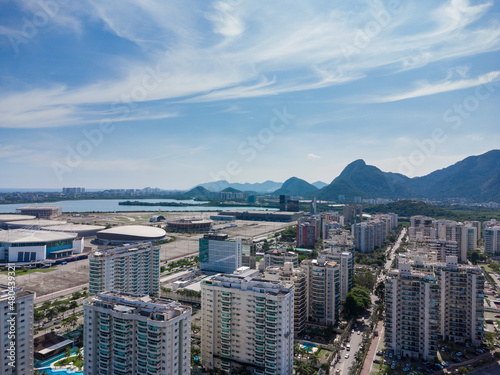Aerial view of Jacarépagua lagoon in Rio de Janeiro, Brazil. Residential buildings and mountains around the lake. Barra da Tijuca beach in the background. Sunny day. Drone photo photo