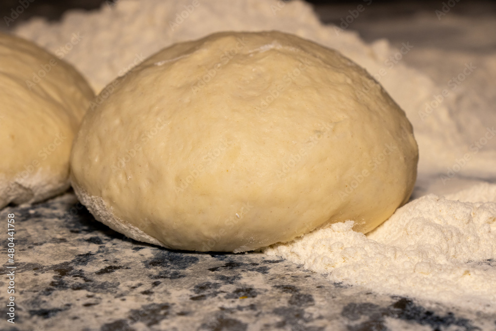 Raw dough with flour on a cutting board. Food photography recipe idea. Raw dough with flour on a cutting board. Food photography recipe idea.