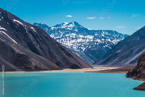 Lake between mountains with snowy peaks in the background in the Andes mountain range