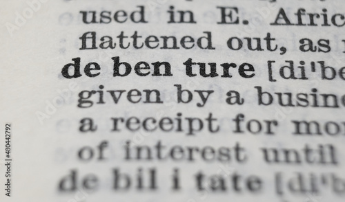 Debenture dictionary definition close-up. Shallow depth of field.