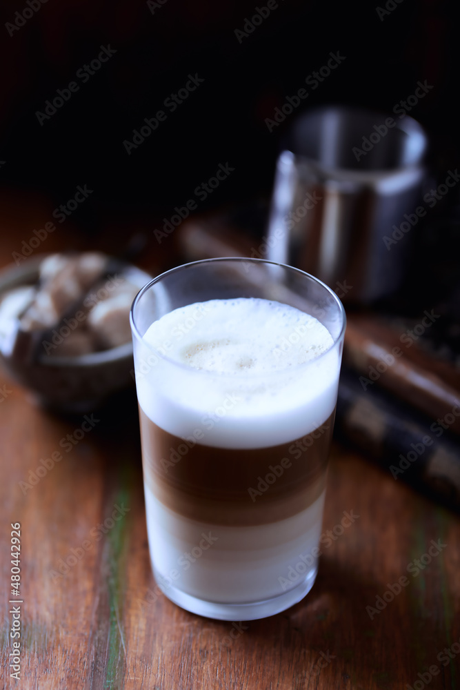 Coffee with milk on wooden background. Soft focus. Close up. Coffee with milk on wooden background. Soft focus. Close up.