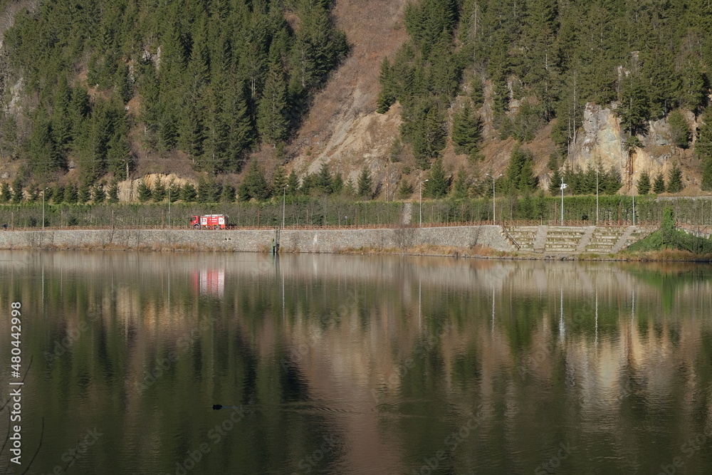 A truck, fire department truck and its reflection on water of uzungol Turkey. Translation of truck itfaiye is fire department. A truck, fire department truck and its reflection on water of uzungol Turkey. Translation of truck itfaiye is fire department.
