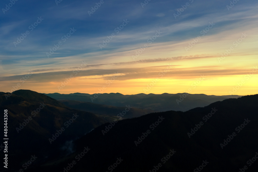 Silhouette of mountain landscape at sunset . Drone photography