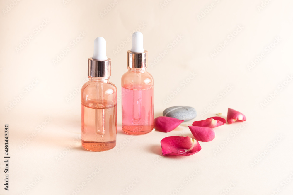 Bottles with pipettes with rose oil for beauty treatments Bottles with pipettes with rose oil for beauty treatments