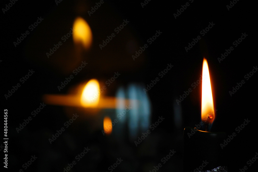Candles burning in darkness. Candles burning in darkness.