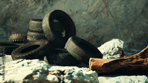 old tires overgrown embedded in the sand
