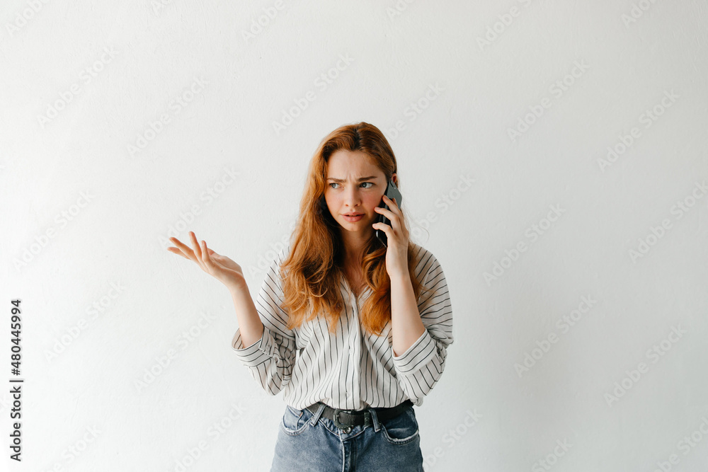 Business woman talking with her employees on the phone, making an important decision, over white background Business woman talking with her employees on the phone, making an important decision, over white background