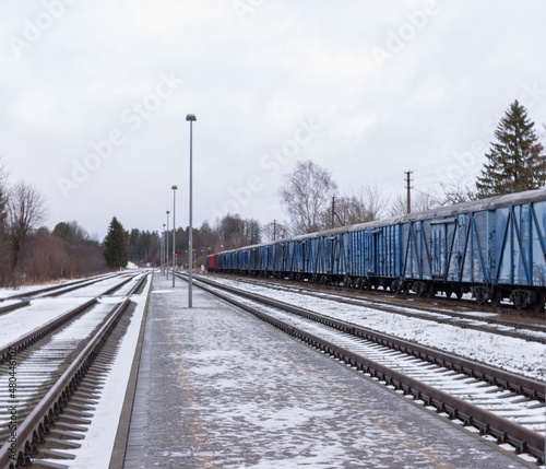Cloudy winter day with passing freight train. photo