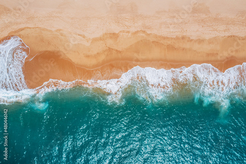 Huge turquoise waves breaking on a lonely sandy beach on Sri Lanka island near Tangalle town Hambantota District. Traveling or exotic Asian countries aerial drone point view concept.