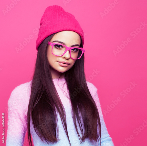 young pretty girl with brunette long hair posing cheerful on pink background  lifestyle people concept