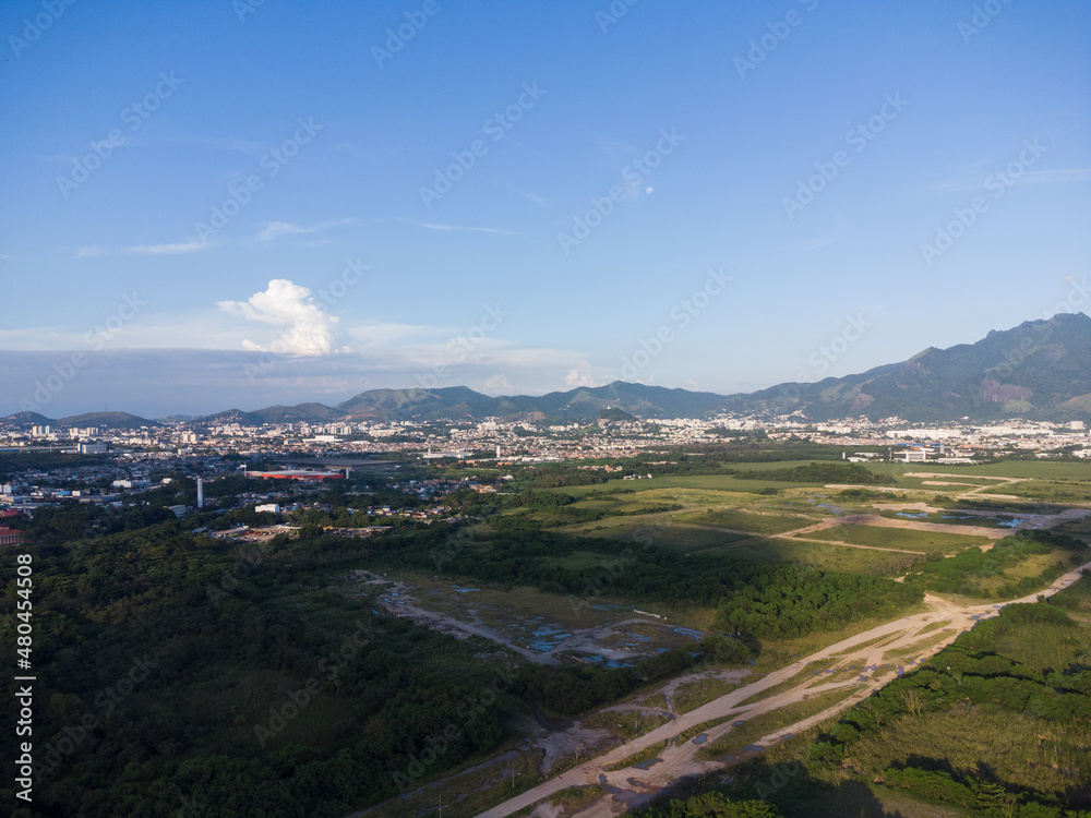 Aerial view of Jacarépagua in Rio de Janeiro, Brazil. Residential buildings and mountains in the background. Sunny day. Sunset Drone photo Aerial view of Jacarépagua in Rio de Janeiro, Brazil. Residential buildings and mountains in the background. Sunny day. Sunset Drone photo