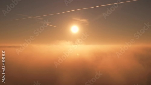 Breathing taking view of sun over the clouds in the airplane