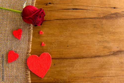 Valentine's Day concept, hearts and rose on wooden table.