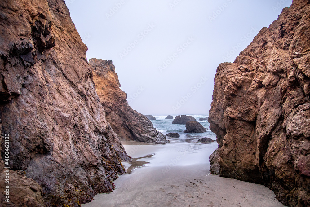 View Through Rocky formations into the Pacific Ocean from the California Coast on a Cloudy Day