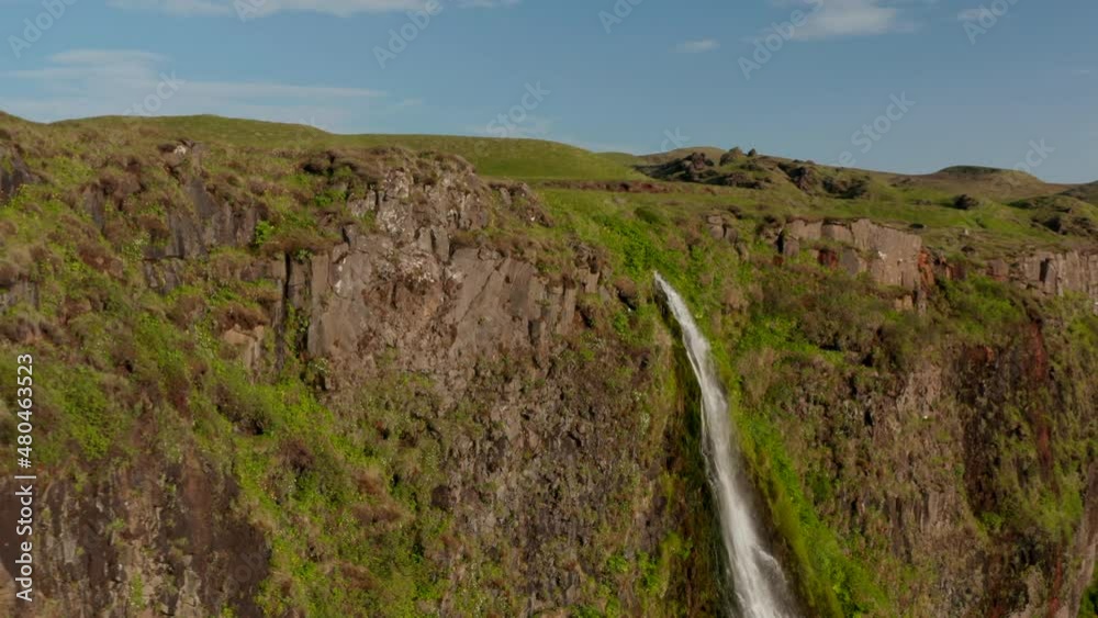 Fly around top edge of rock. Water falling into depth of Seljalandsfoss waterfall. Preserved Nordic landscape. Iceland Fly around top edge of rock. Water falling into depth of Seljalandsfoss waterfall. Preserved Nordic landscape. Iceland