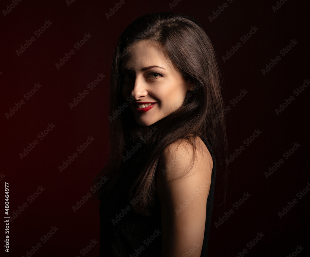 Beautiful happy laughing woman with red lipstick with bright makeup on dark red background with empty copy space. Closeup Beautiful happy laughing woman with red lipstick with bright makeup on dark red background with empty copy space. Closeup