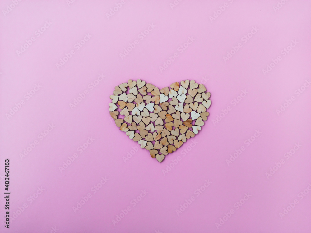 A big heart made of many small wooden hearts on a pink-purple background. Cute Valentine's Day card