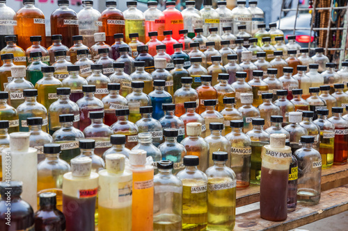 Aromatic oils being sold by a sidewalk vendor.