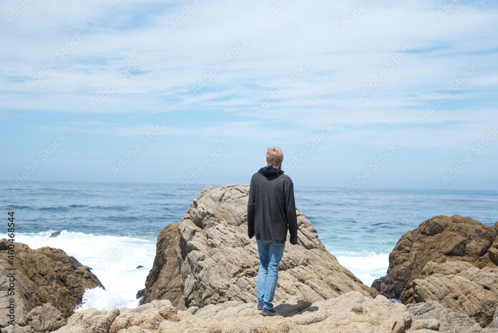Adventurous Man Standing on Cliffs Along Pacific Coast Highway One in California