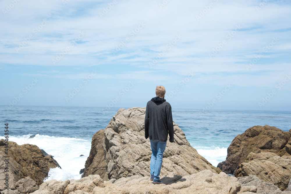 Adventurous Man Standing on Cliffs Along Pacific Coast Highway One in California Adventurous Man Standing on Cliffs Along Pacific Coast Highway One in California