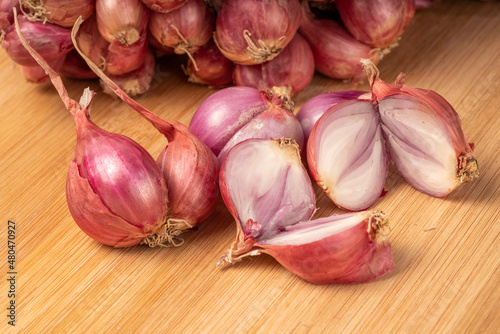 Shallots or Red Onion, Asian herbs and cooking ingredients on wooden background.