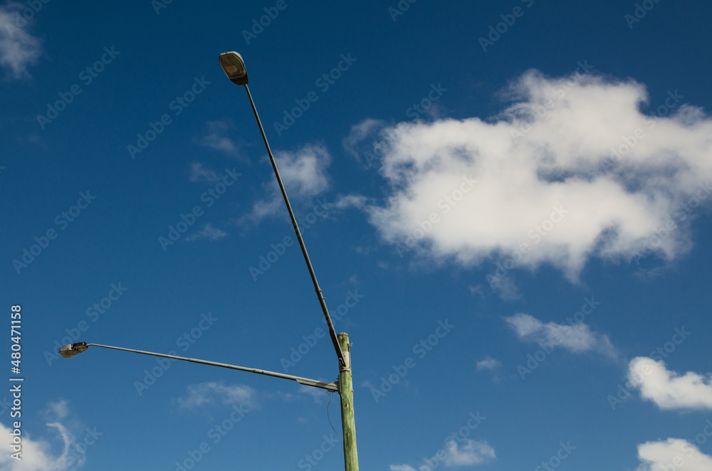The twin street Lamp pole for outdoor lighting with blue sky in the background. The twin street Lamp pole for outdoor lighting with blue sky in the background.