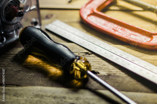 Collection of woodworking tools on a wooden background.