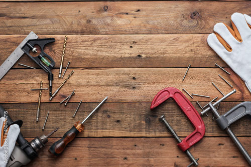 Collection of woodworking tools on a wooden background.