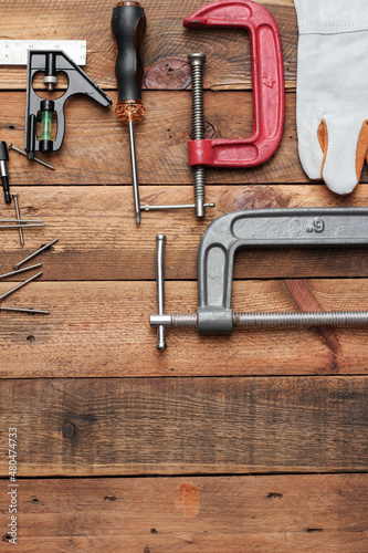 Collection of woodworking tools on a wooden background.
