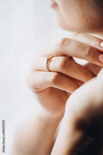 close up of hands holding a ring