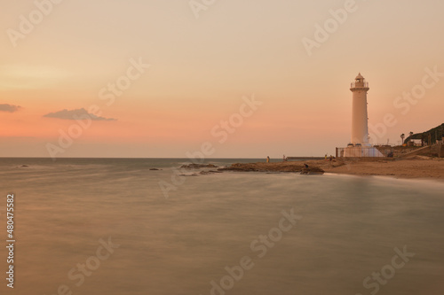 海辺の灯台と夕陽写真、スローシャッター撮影