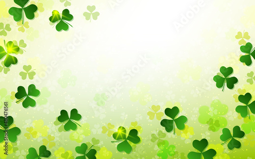 St.Patrick's Day blurred vector background with clover leaves and light effects