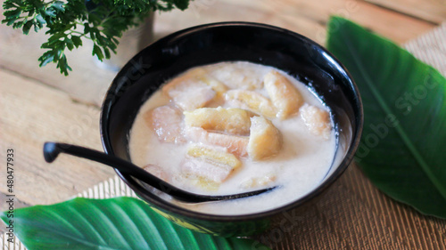 Banana in Coconut Milk on wood table Traditional dessert of asian, Thailand.