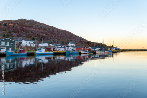 Canvas-taulu A view of Petty Harbour, Newfoundland, a small fishing village with a sheltered harbor surrounded by small fishing boats