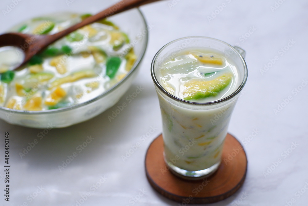 selective focus of iced mix fruit and milk in a glass against nature background selective focus of iced mix fruit and milk in a glass against nature background