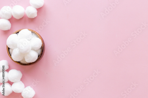 Delicate soft cotton balls in bowl. Cosmetic makeup remover supplies