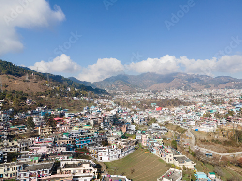 Aerial view of a Pithoragarh. Drone shot of a city situated in between the mountains. © Yogendra