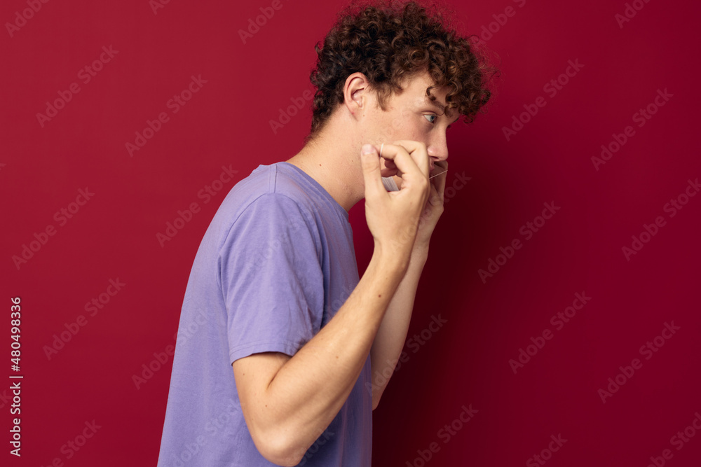 kinky guy in purple t-shirts medical mask in hands safety isolated background unaltered kinky guy in purple t-shirts medical mask in hands safety isolated background unaltered