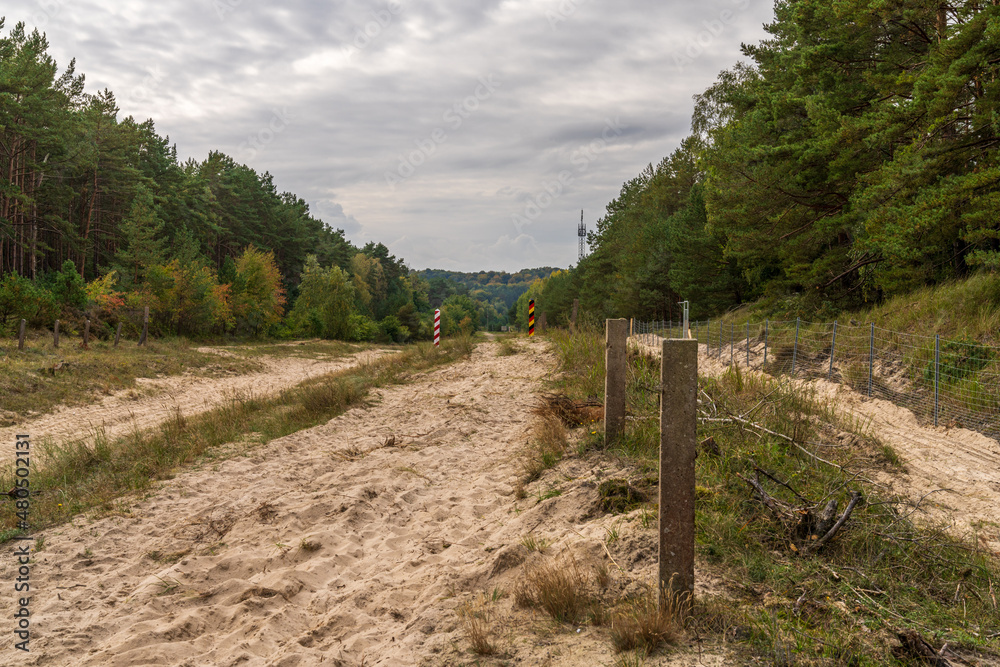 Fototapeta premium The no man's land on the border between Ahlbeck in Germany and Swinoujscie in Poland with two boundary posts