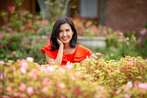 beautiful woman with red shirt on her garden