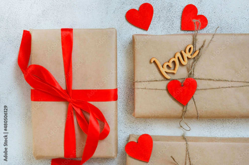 valentines day greeting card close up, festive gift box with red ribbon and wooden decorations shape heart, eco craft package and zero waste holiday valentines day greeting card close up, festive gift box with red ribbon and wooden decorations shape heart, eco craft package and zero waste holiday