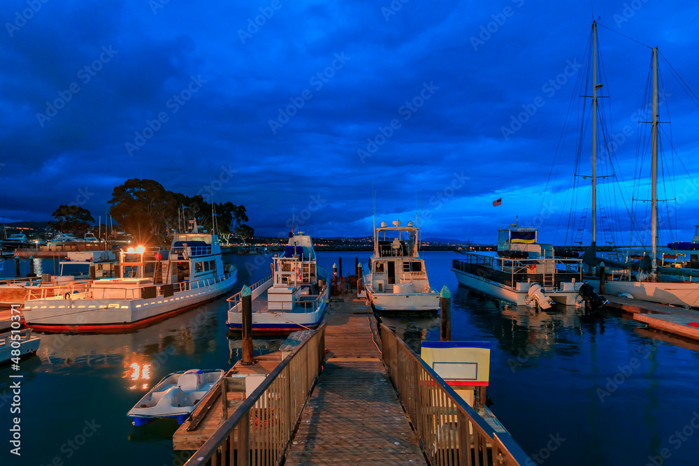 Fishing boats docked in Dana Point harbor, Orange county in Southern California at the blue hour of the sunset Fishing boats docked in Dana Point harbor, Orange county in Southern California at the blue hour of the sunset