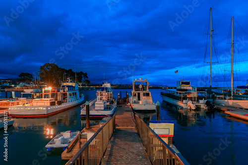 Fishing boats docked in Dana Point harbor, Orange county in Southern California at the blue hour of the sunset
