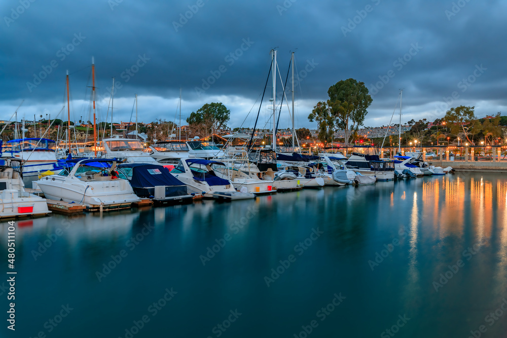 Sunset over luxury yachts and boats in Dana Point harbor, Orange County in Southern California