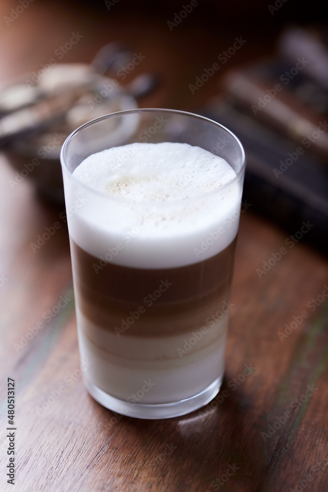 Coffee with milk on wooden background. Soft focus. Close up. Coffee with milk on wooden background. Soft focus. Close up.