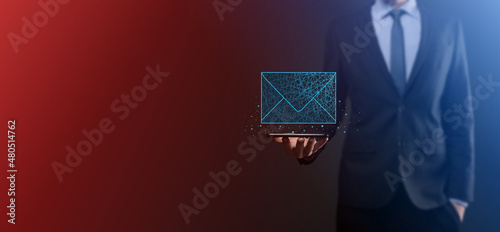 Businessman hand holding letter icon,email icons.Contact us by newsletter email and protect your personal information from spam mail.Customer service call center contact us.Email marketing newsletter. © Ivan